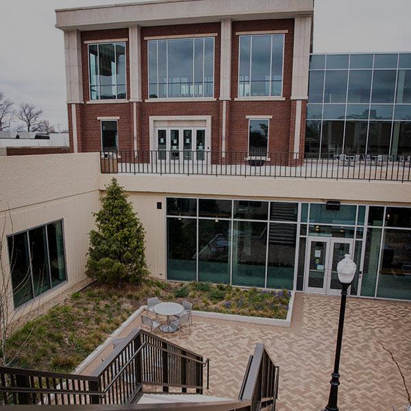 Lower courtyard with trees and upper building at the Bone Student Center.